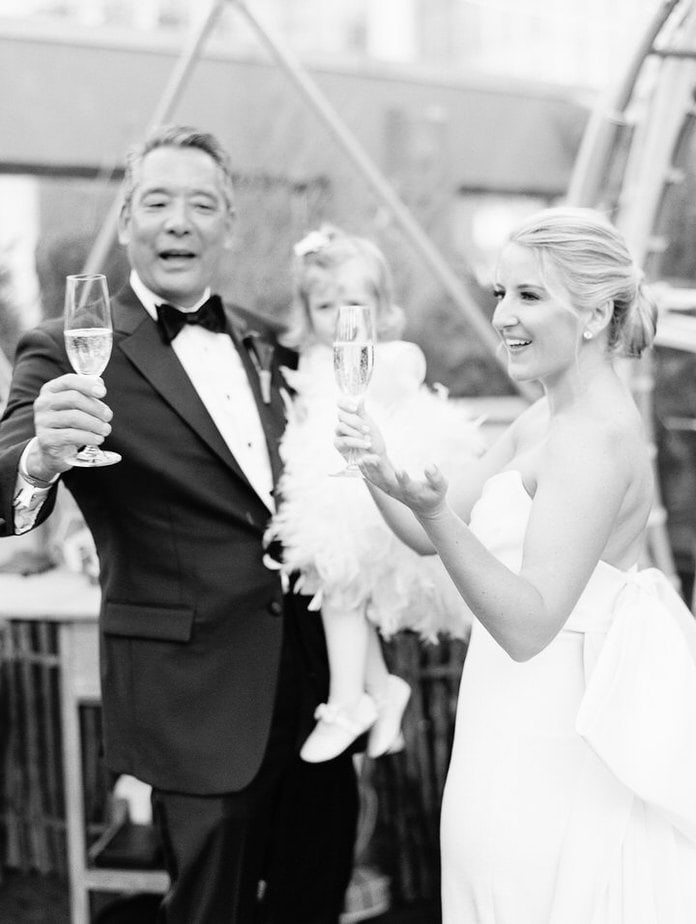 bride and her dad toasting champagne