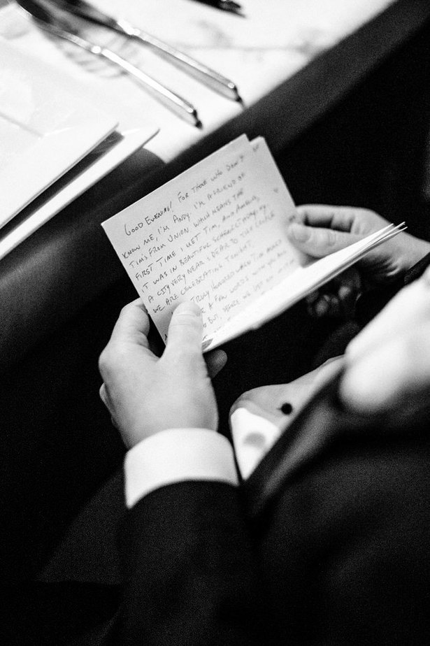 hands holding a handwritten speech